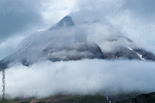 view of the gloomy peak of an extinct volcano, enveloped in fog and mystery © Valeryet