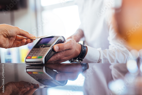 Customer using NFC technology for payment at bar