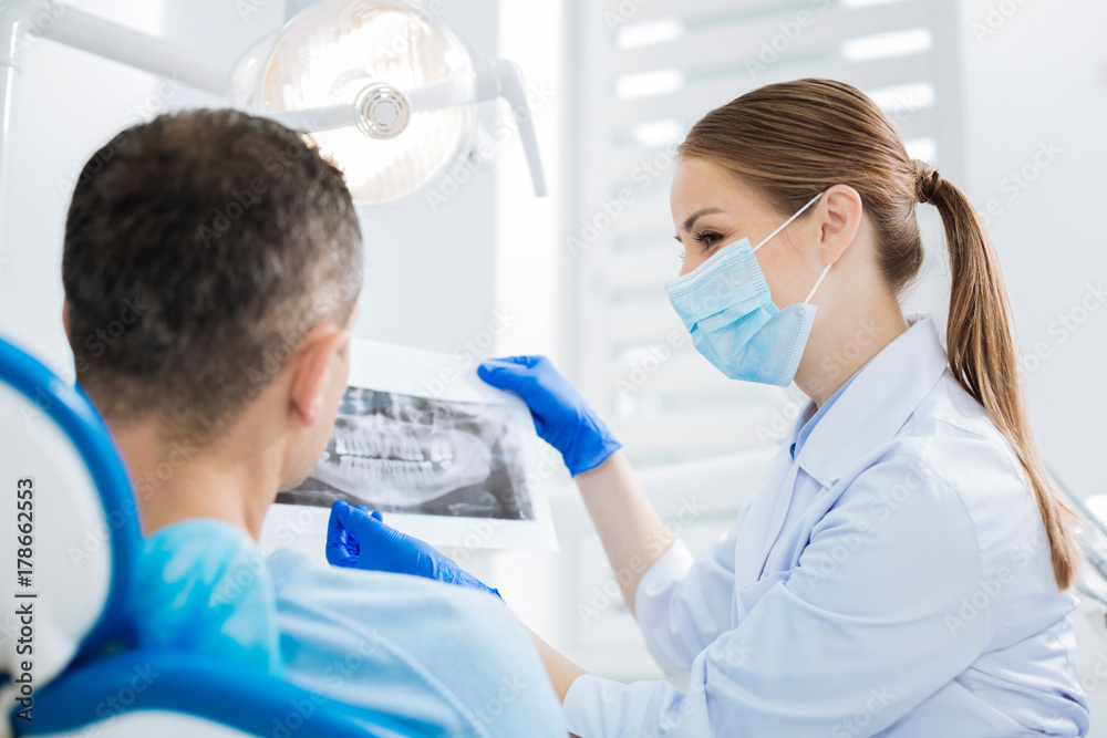 Delighted cheerful doctor talking to the patient Delighted cheerful doctor talking to the patient