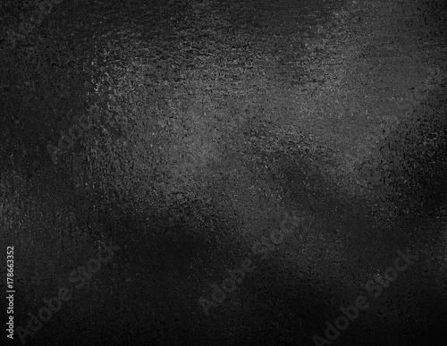 Black foil textured background. Dark elegant smooth metallic texture.