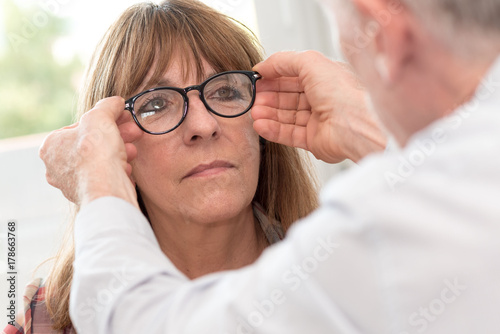 Mature woman testing new eyeglasses