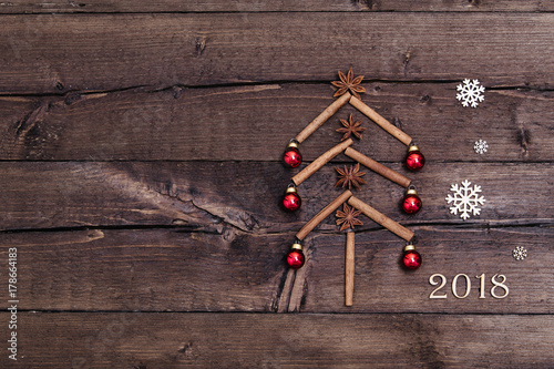 Sigh symbol from number 2018 on vintage style wooden texture background. Happy New Year 2018 greetings on wooden. Empty space for your text. Christmas background with decorations, xmas tree and gift