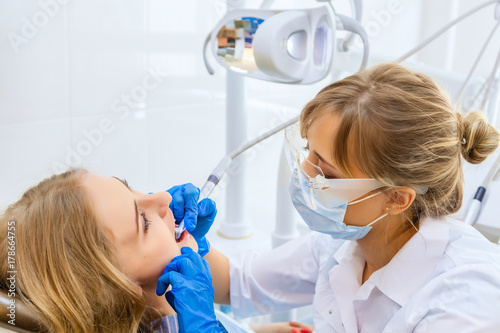 Young Professional Woman Dentist with a Female Patient