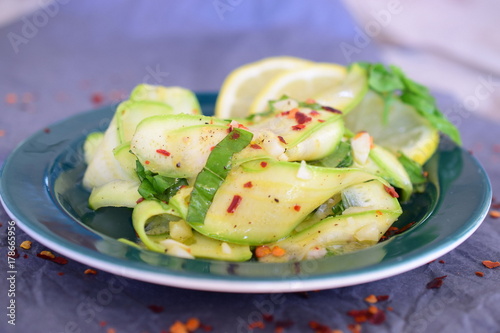 Salad with fresh zucchini , basil, lemon, garlic and olive oil. photo