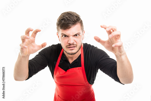 Male supermarket employer holding hands like scaring someone