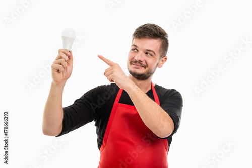 Male supermarket employer pointing light bulb like good idea