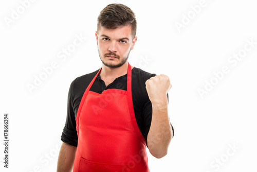 Male supermarket employer holding fist looking mad