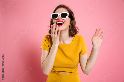 Portrait of a happy young woman in sunglasses
