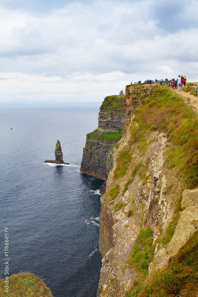 Cliffs of Moher, west coast of Ireland, County Clare on wild Atlantic ocean. Photo of a beautiful scenic sea and sky landscape. View of ocean scenery, vertical