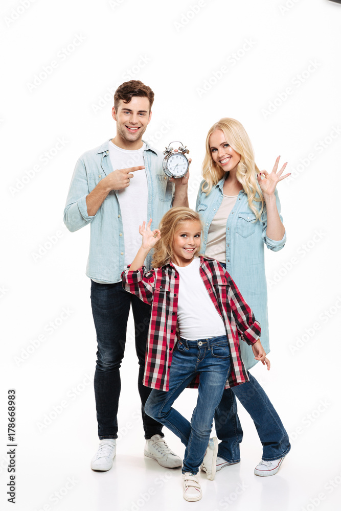 Full length portrait of a happy family with a child