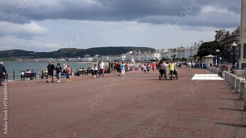 Llandudno, UK - August 8th, 2014. The promenade at the seaside resort of llandudno in wales promenade with visitors walking.

EDITORIAL