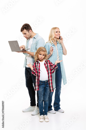 Full length portrait of a family talking on mobile phone