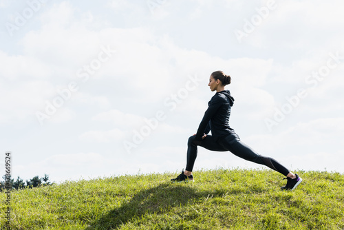 fit woman stretching legs