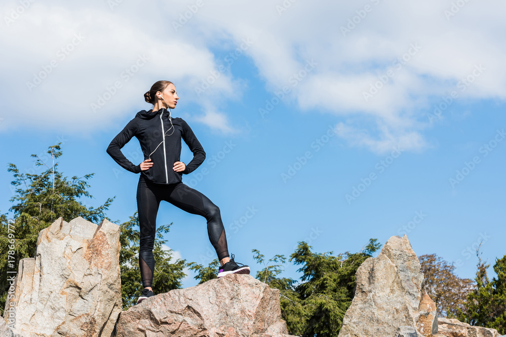 young sportive woman on rocks