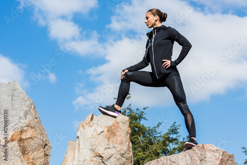 young sportive woman on rocks © LIGHTFIELD STUDIOS