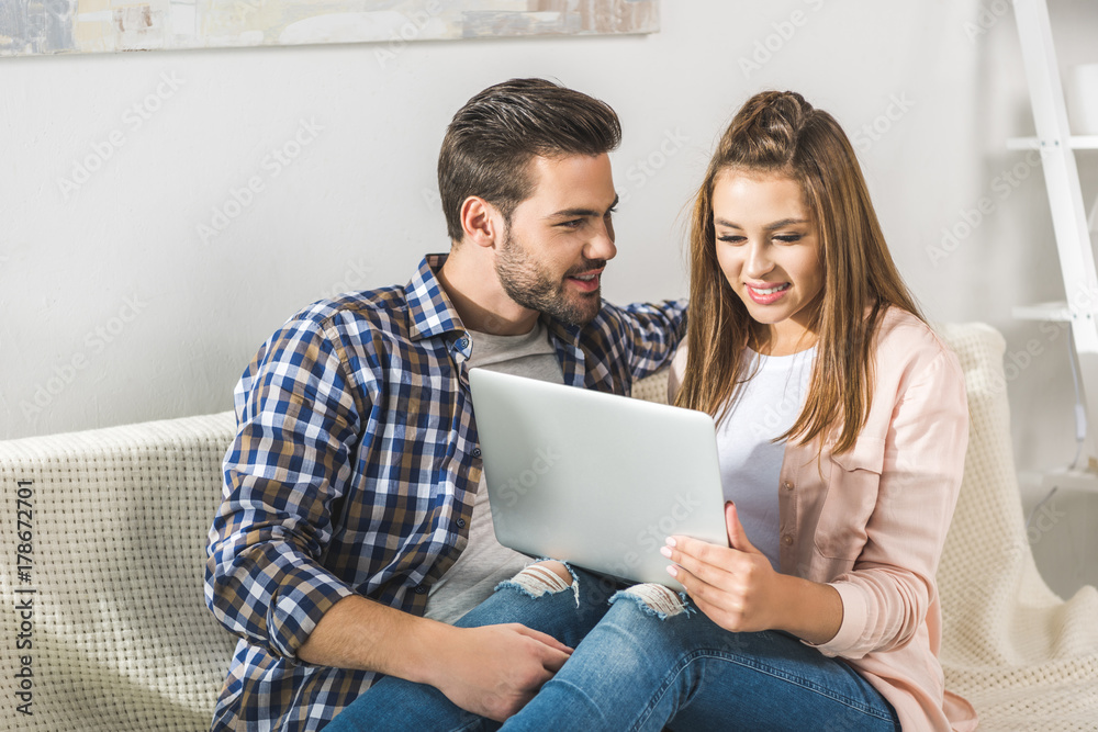 attractive couple using laptop attractive couple using laptop