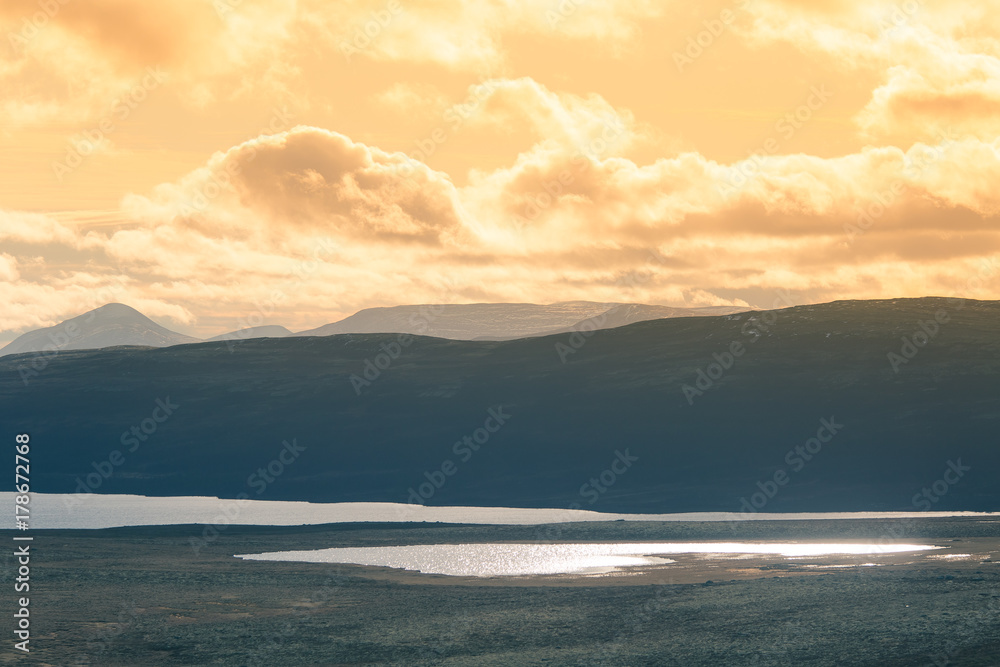 A beautiful mountain landscape with a lake in the distance. Autumn mountains in Norway. Fall scenery in Scandinavia. A beautiful mountain landscape with a lake in the distance. Autumn mountains in Norway. Fall scenery in Scandinavia.