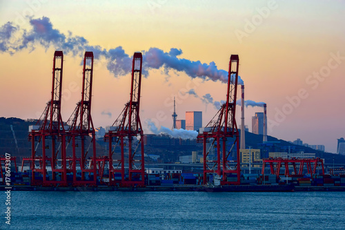 Containers loading by crane with sunrise. photo