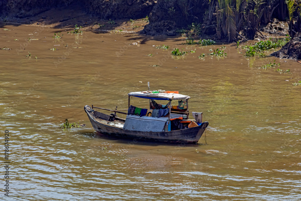 An old wooden boat anchored in the Soai Rap river An old wooden boat anchored in the Soai Rap river