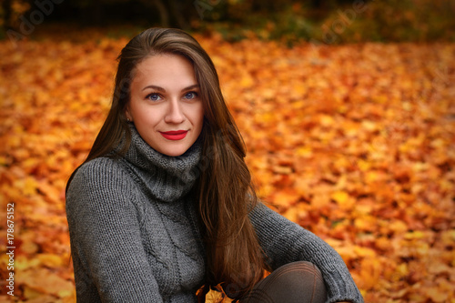 Beautiful girl with long hair in autumn park