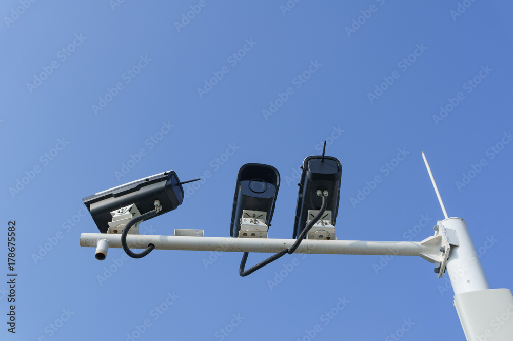 Security cameras with blue sky background