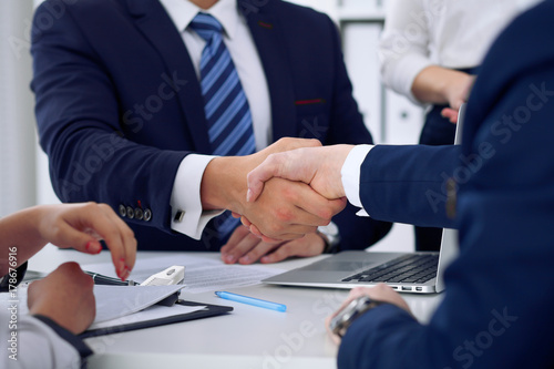 Business handshake at meeting or negotiation in the office, close-up. Partners are satisfied because signing contract or financial papers © rogerphoto
