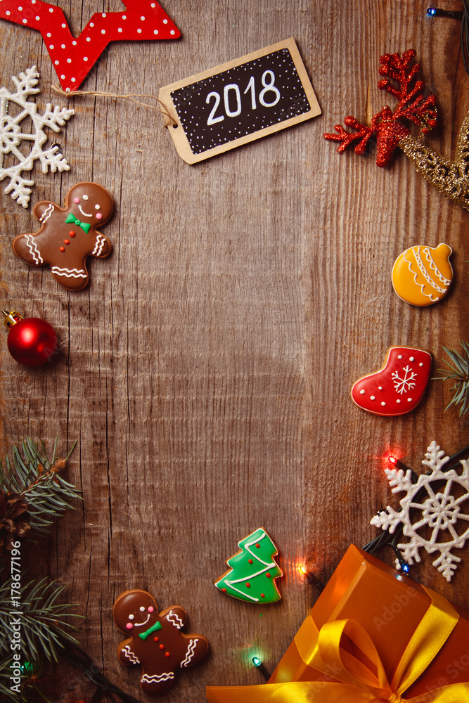 Beautiful Christmas background with gingerbreads, sweets and gift on wooden background. Merry Christmas postcard 2018 Beautiful Christmas background with gingerbreads, sweets and gift on wooden background. Merry Christmas postcard 2018