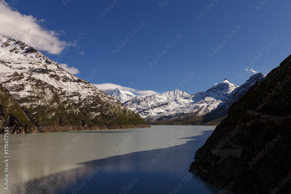 wavy coast of the Alpine mountains from the lake with emerald water. Landscape of nature in the Nordic style