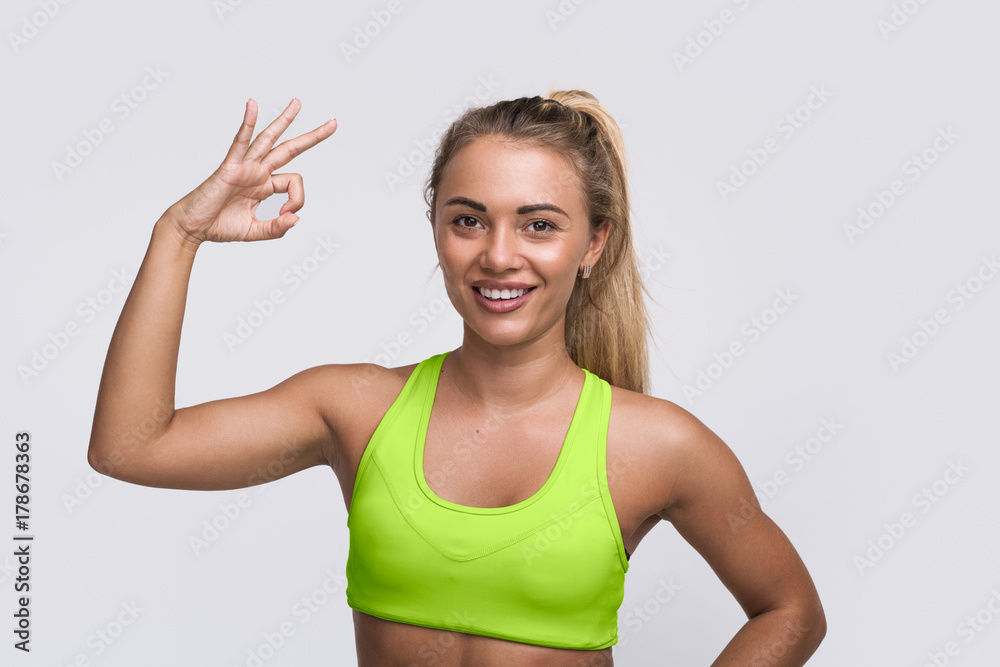 Cheerful sportswoman gesturing at camera Cheerful sportswoman gesturing at camera