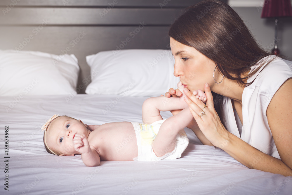 happy mother with baby on bed happy mother with baby on bed