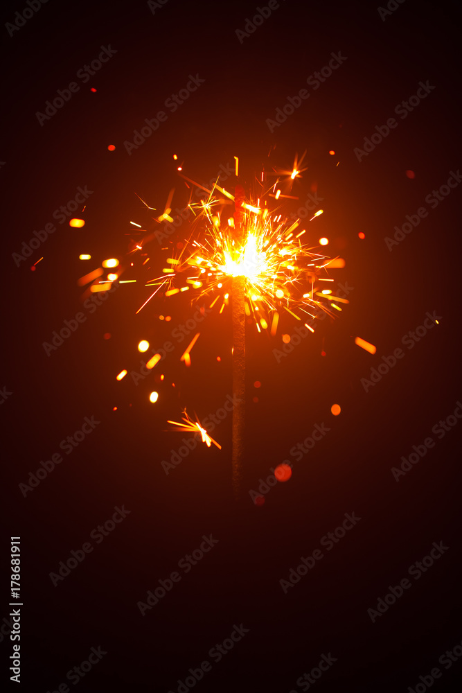 Obraz premium Christmas sparkler in haze with red light