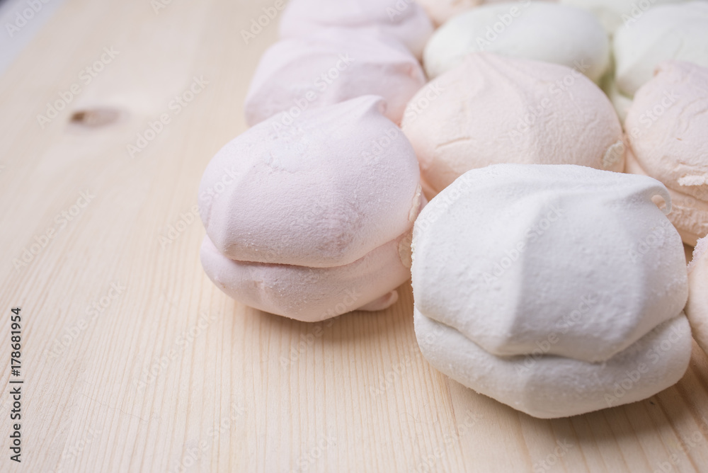 Multicolored marshmallow on a wooden background Multicolored marshmallow on a wooden background