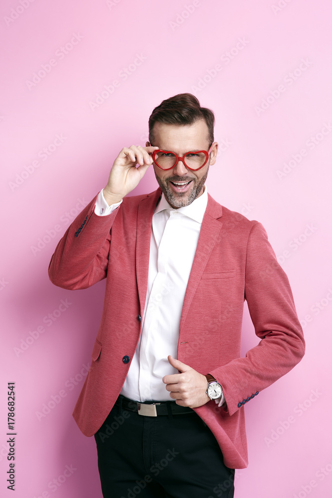 Cheerful man with heart shape eyeglasses posing