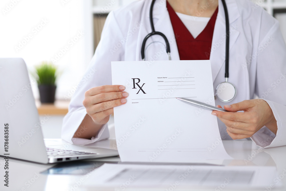 Female medicine doctor hand hold clipboard pad and give prescription to patient closeup. Panacea and life save, prescribe treatment, legal drug store, contraception concept. Empty form ready to be Female medicine doctor hand hold clipboard pad and give prescription to patient closeup. Panacea and life save, prescribe treatment, legal drug store, contraception concept. Empty form ready to be