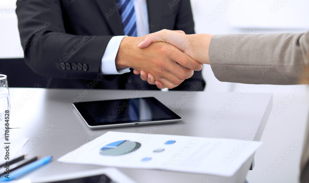 Business people shaking hands, finishing up a meeting Business people shaking hands, finishing up a meeting