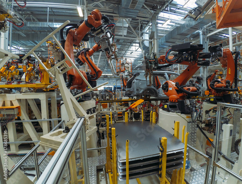 Automobile plant, modern production of cars, robot equipment, automated production line. 