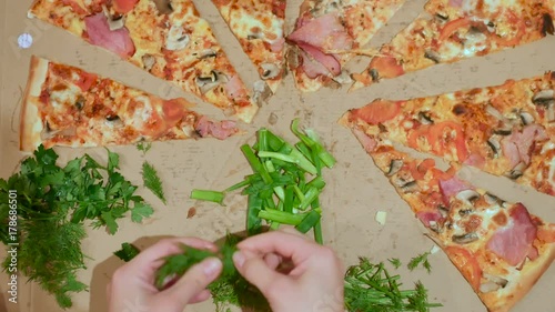woman hands prepare herbs for pizza photo