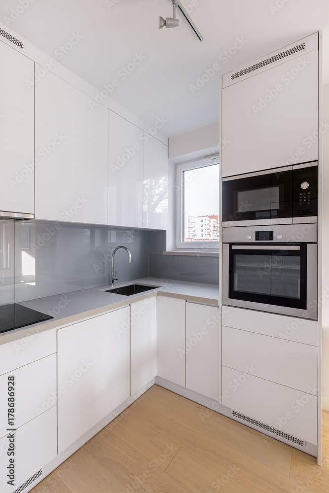 White kitchen with gray tiles White kitchen with gray tiles