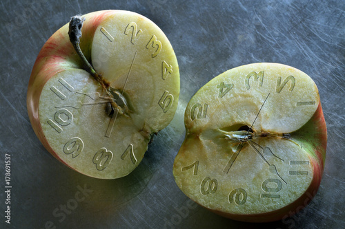 Two halves of apples with a clock face
