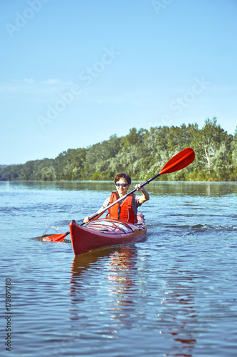 A canoe trip along the river along the forest in summer. © trek6500