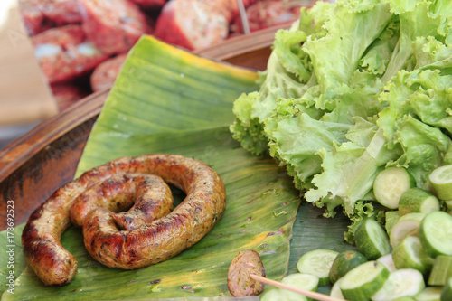 Thai cuisine, grilled Thai sausages Northern style on banana leaf ready for sale. photo