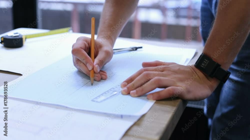 Engineer builder works with drawings in the office Engineer builder works with drawings in the office