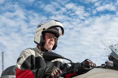 portrait of a senior biker on his motorcycle