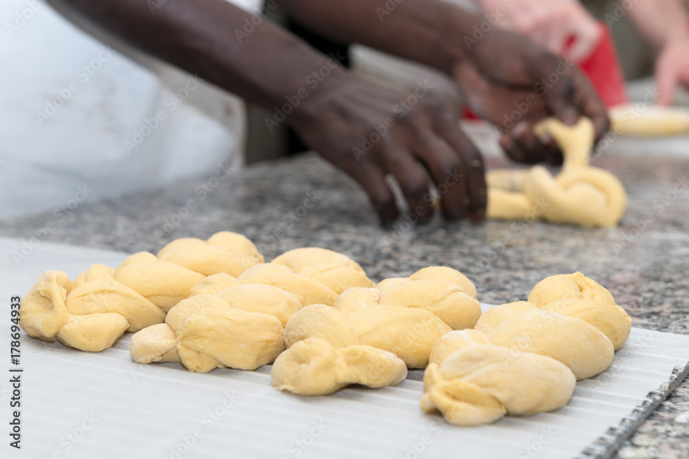 baker prepares bread dough in his bakehouse