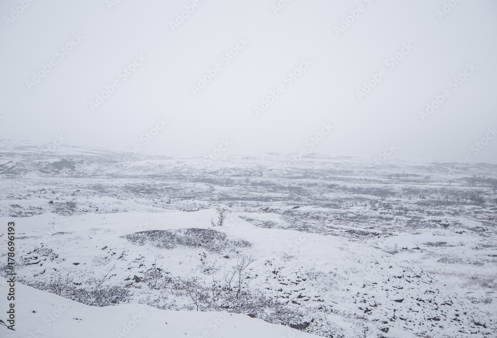 Obraz premium A beautiful Norwegian landscape in first snow in autumn. White, snowy scenery.