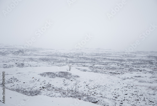 A beautiful Norwegian landscape in first snow in autumn. White, snowy scenery.