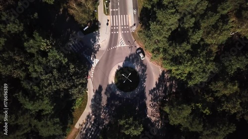 Small roundabout aerial shot. Road in the forest.4k Cars driving photo