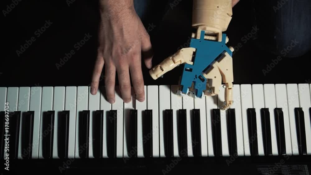 Robot plays a musical instrument. man musician pianist with a