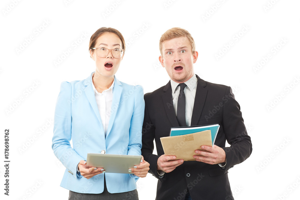 Portrait of Asian businesswoman and Caucasian businessman holding tablet computer and documents Portrait of Asian businesswoman and Caucasian businessman holding tablet computer and documents
