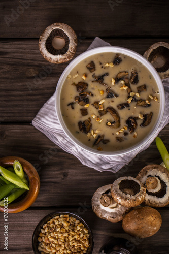 mushroom soup shot on wood boards top view loose mushrooms scallions hazelnuts portrait1